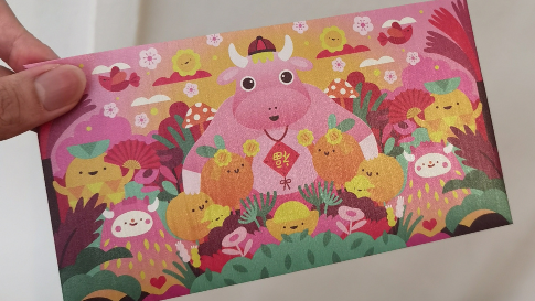 Illustrated golden ox greeting emerging from a red packet in AR